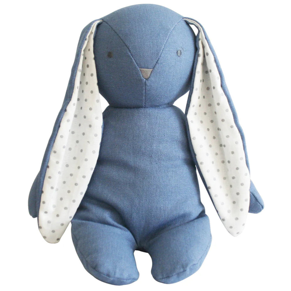 Blue plush bunny toy with white polka dot ears on a white background
