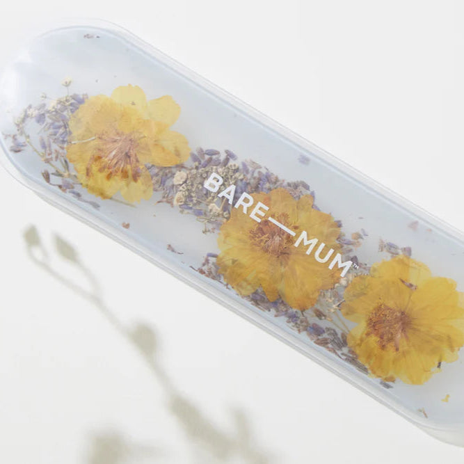 Clear container with yellow flowers and 'BARE MUM' text on a white background