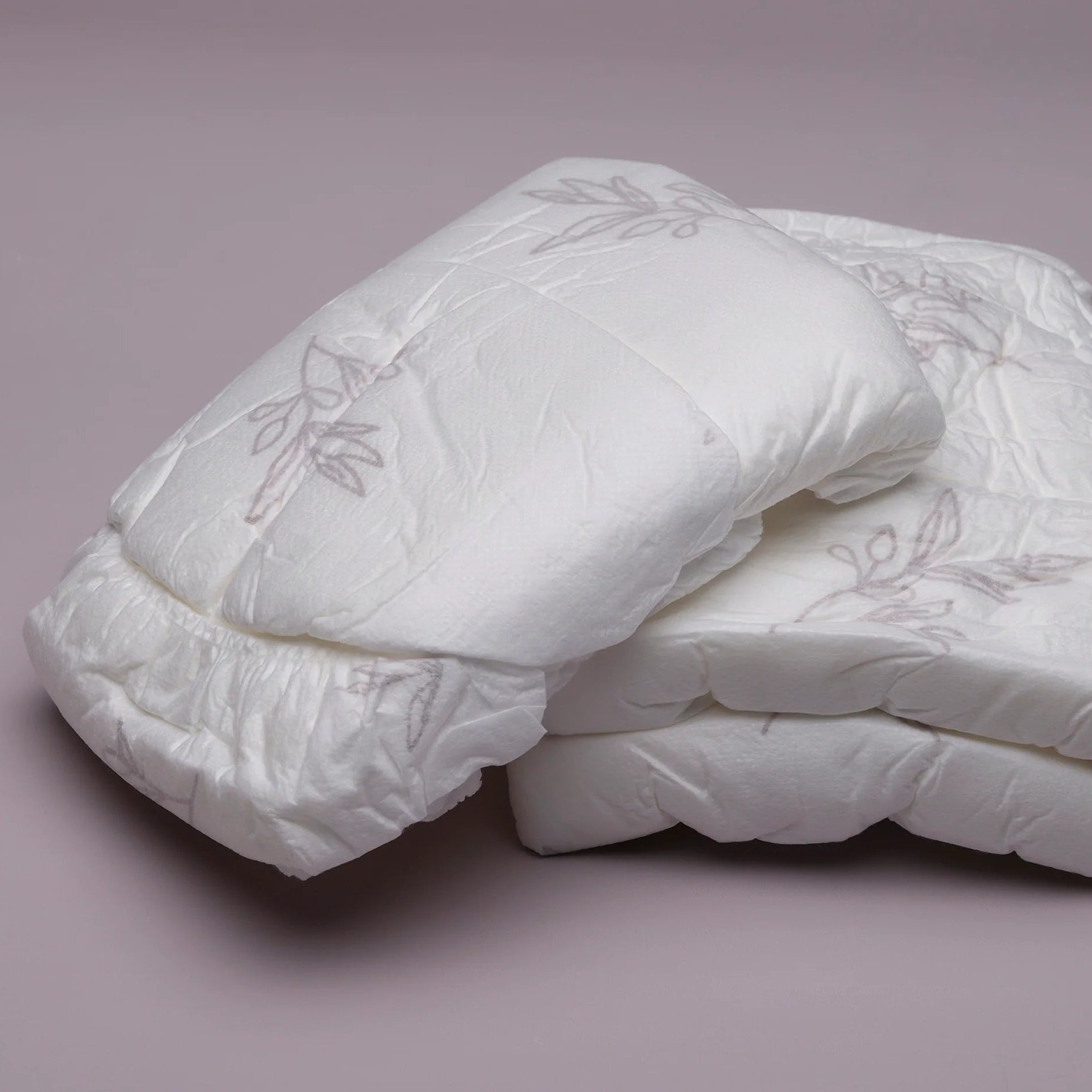 Stack of white disposable postpartum underwear