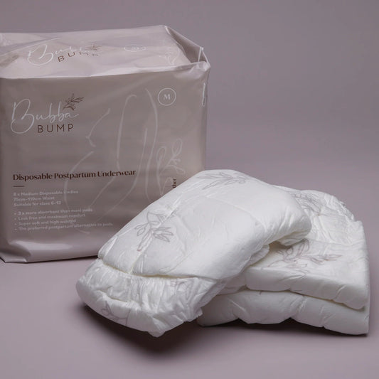 Disposable postpartum underwear with packaging on a gray background