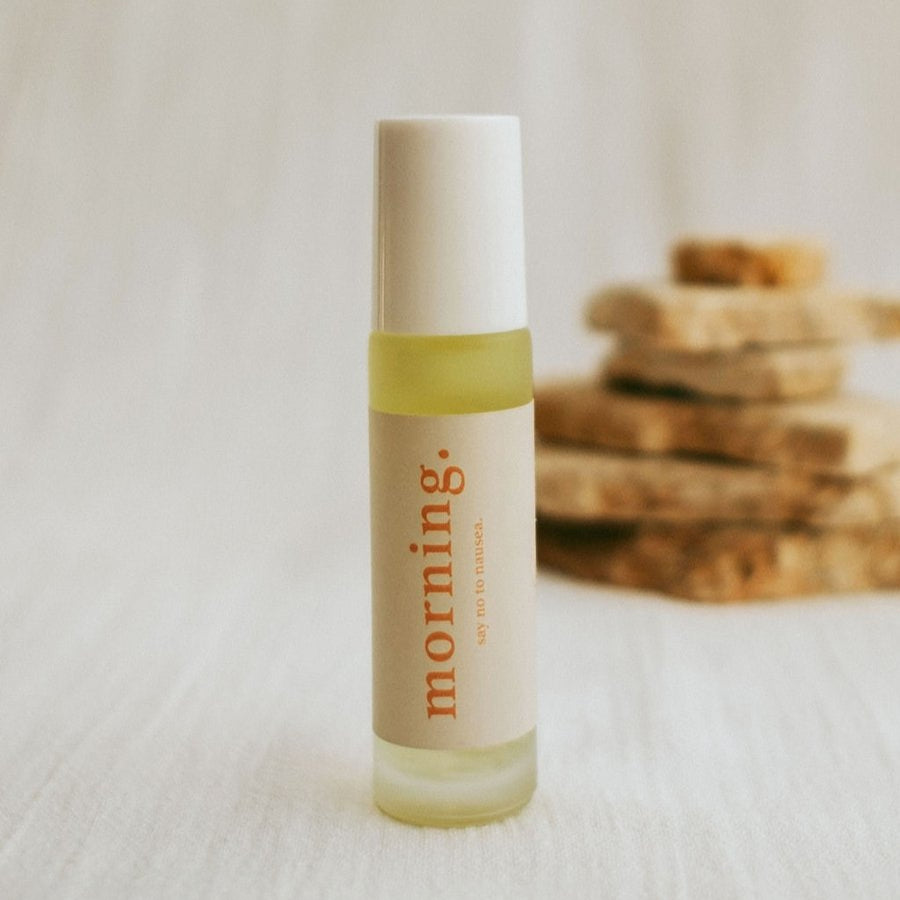 Small bottle labeled 'morning' on a white surface with a blurred background