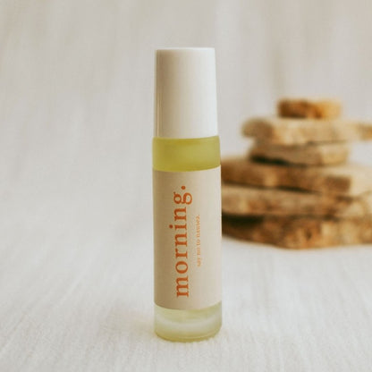 Small bottle labeled 'morning' on a white surface with a blurred background