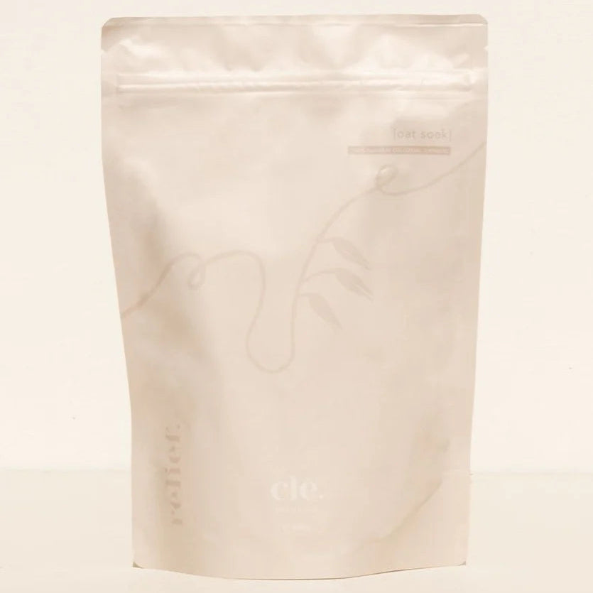 White stand-up pouch with oatmeal bath soak on a beige background