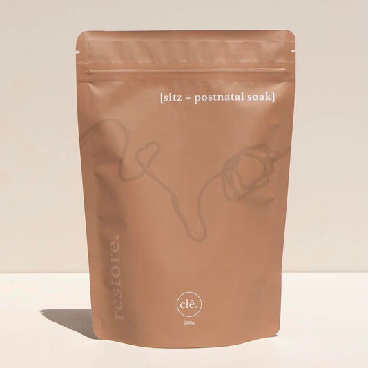 Brown bath salts pouch with sitz & postnatal soak on a beige background