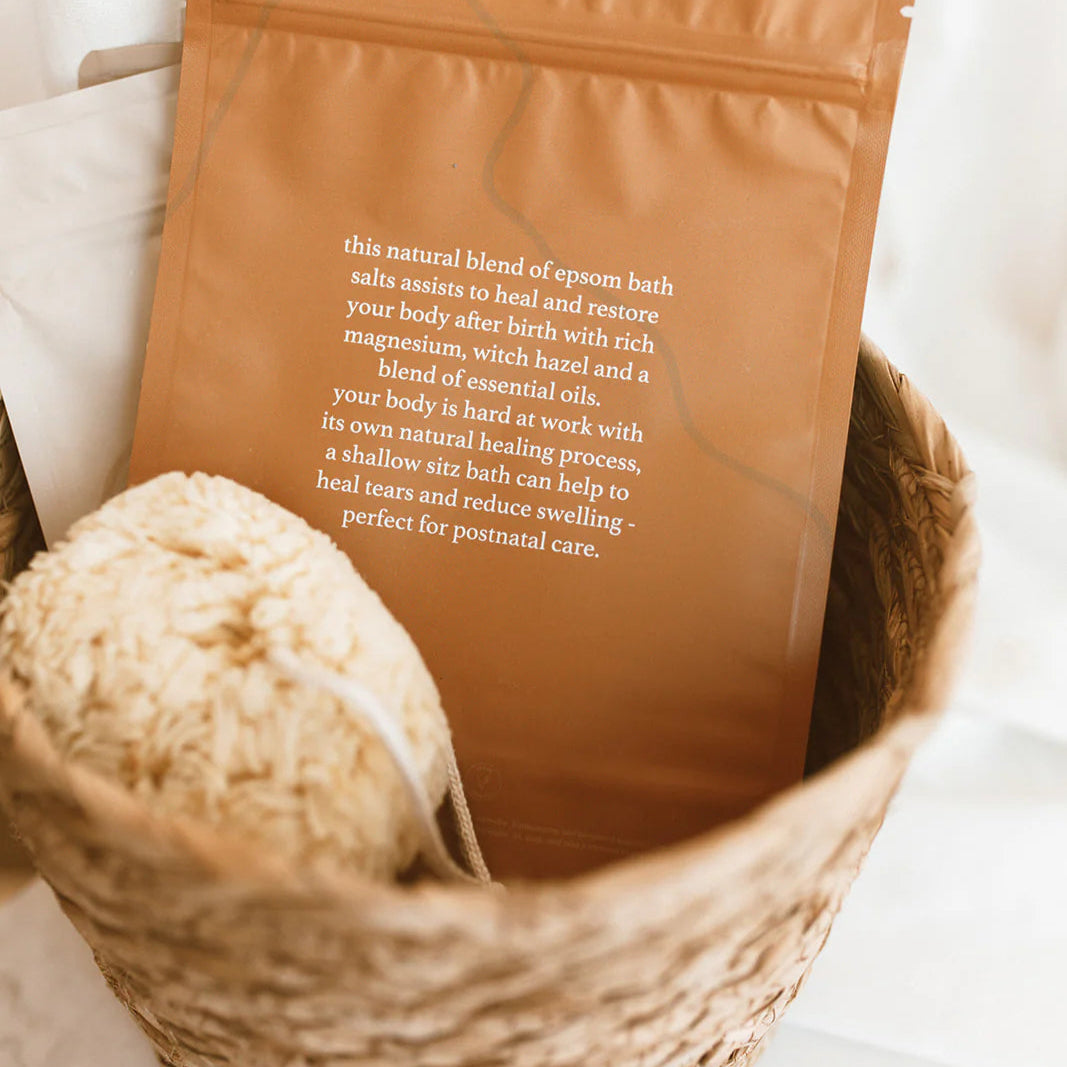 Brown package with text in a woven basket on a light background