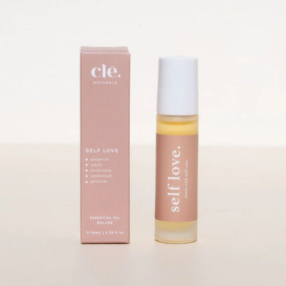 Roll-on bottle and box of 'self love' essential oil on a light background
