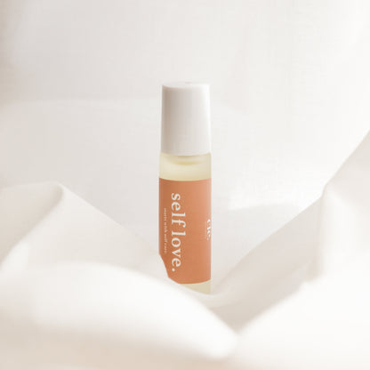 Bottle of 'selflove' serum on a soft white background