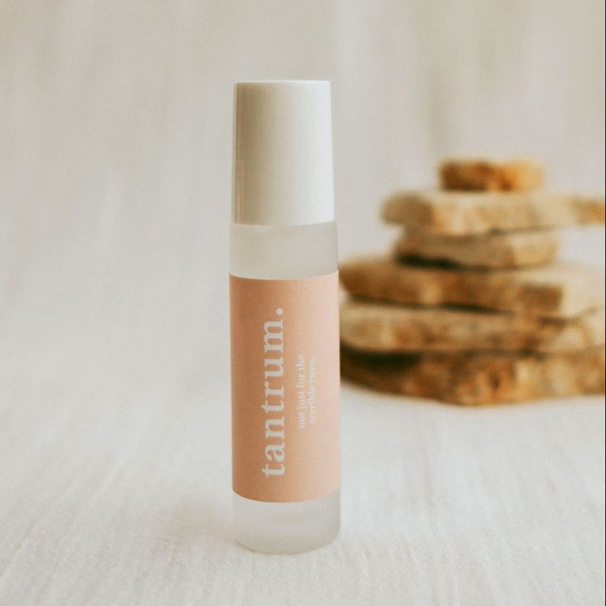 Cle Naturals Essentials Oil roller bottle with 'tantrum' branding on a neutral background