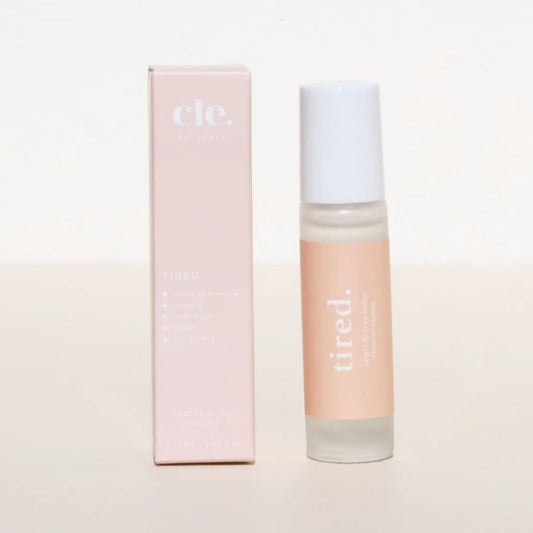 Cle Tired Essentials Oil bottle and box on a light background