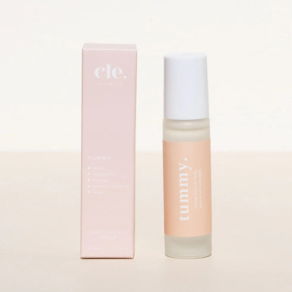 Cle Tummy Essentials Oil roller and packaging on a light pink background