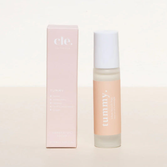 Cle Tummy Essentials Oil roller and packaging on a light pink background