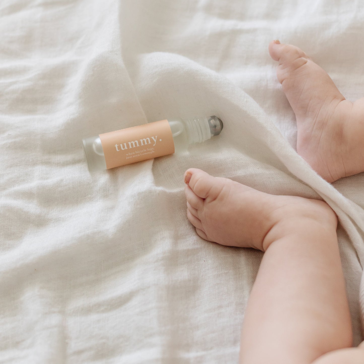 Cle Tummy Essentials Oil Roller bottle on a white textured surface