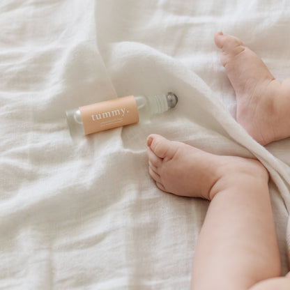 Cle Tummy Essentials Oil Roller bottle on a white textured surface