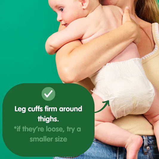 Woman holding a baby wearing a Comfy Koalas eco nappies with text on a green background