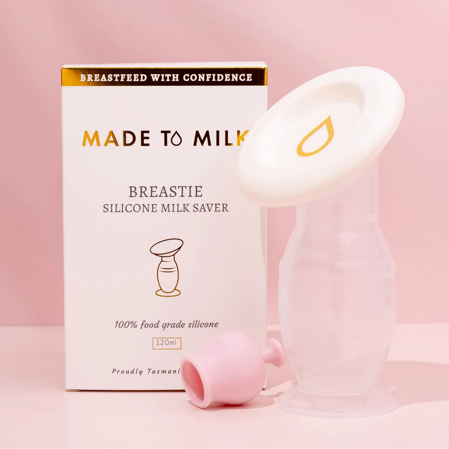 Silicone milk saver with packaging on a pink background