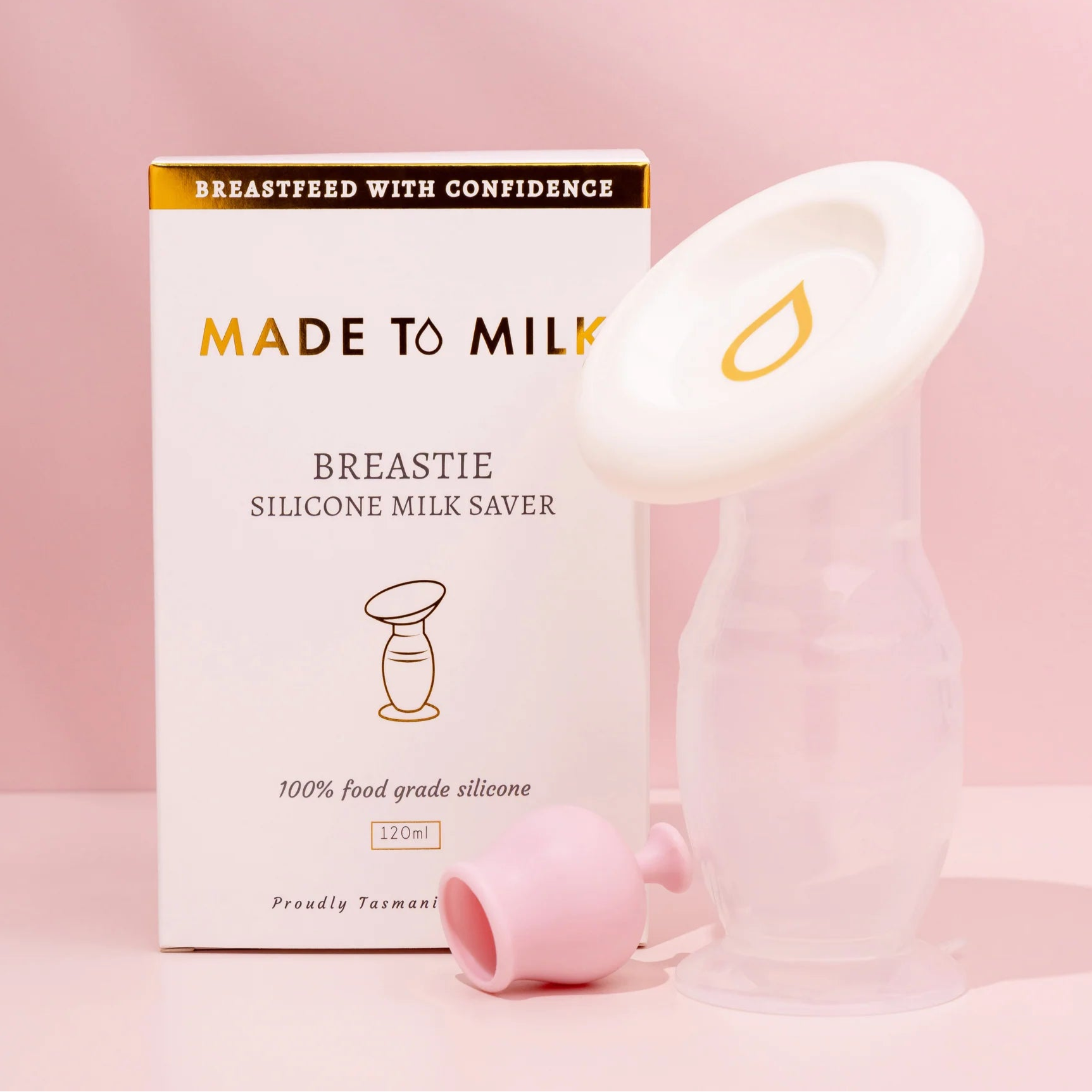 Silicone milk saver with packaging on a pink background