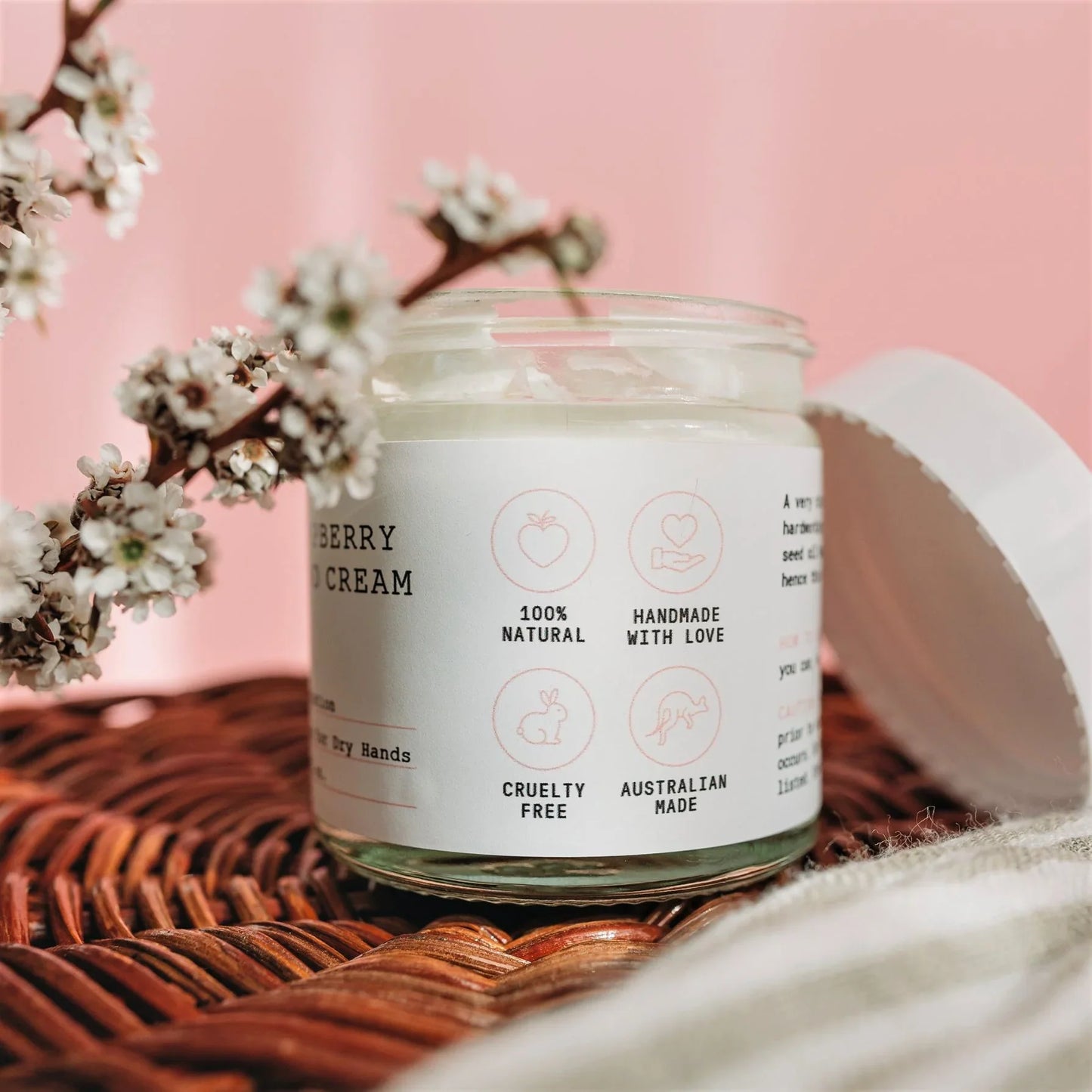 Wild Jasmine Soufflé  jar labeled 'Berry Cream' with cherry blossoms on a pink background