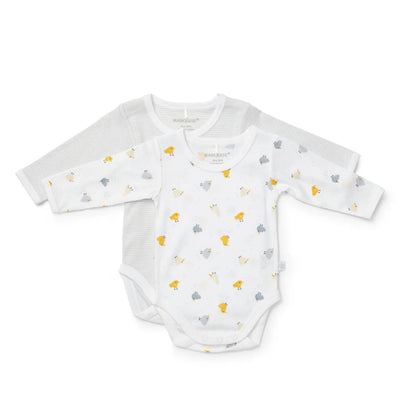 White baby onesie with small colorful patterns on a white background