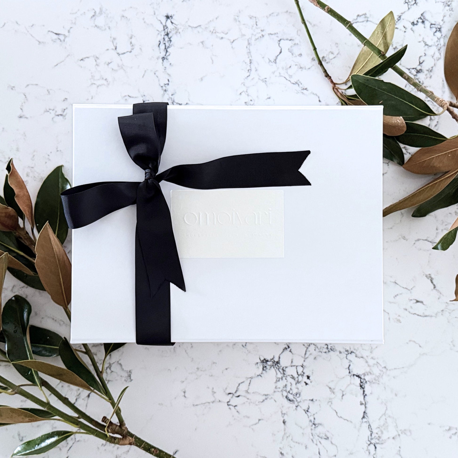 Omoiyari gift hamper box - wrapped in a black bow tie ribbon with an Omoiyari label sticker