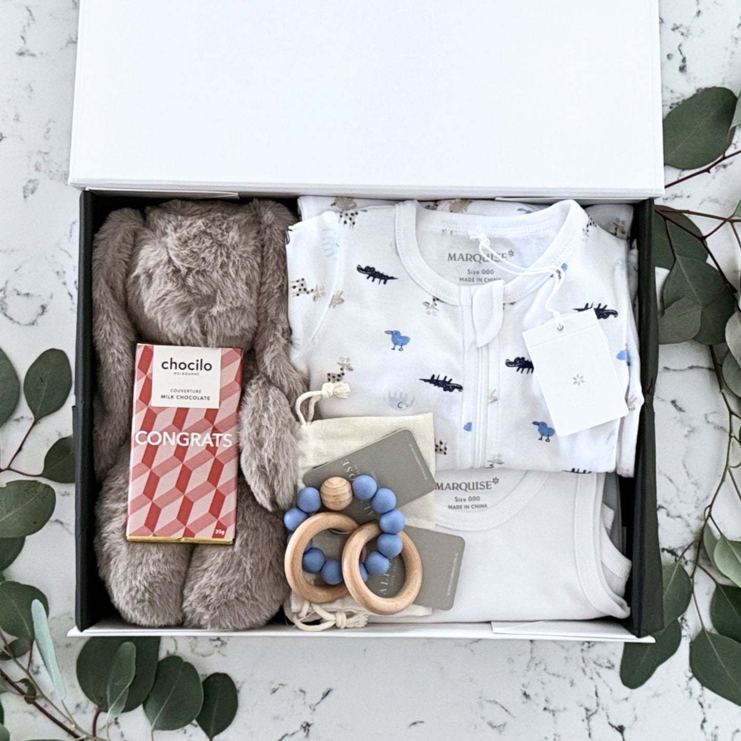 Omoiyari Hello Baby Boy Luxe Gift hamper box -  blue bunny plush toy, chocolate, Maraquise baby clothing, baby journal rattle and a teething ring with green gum leaves.