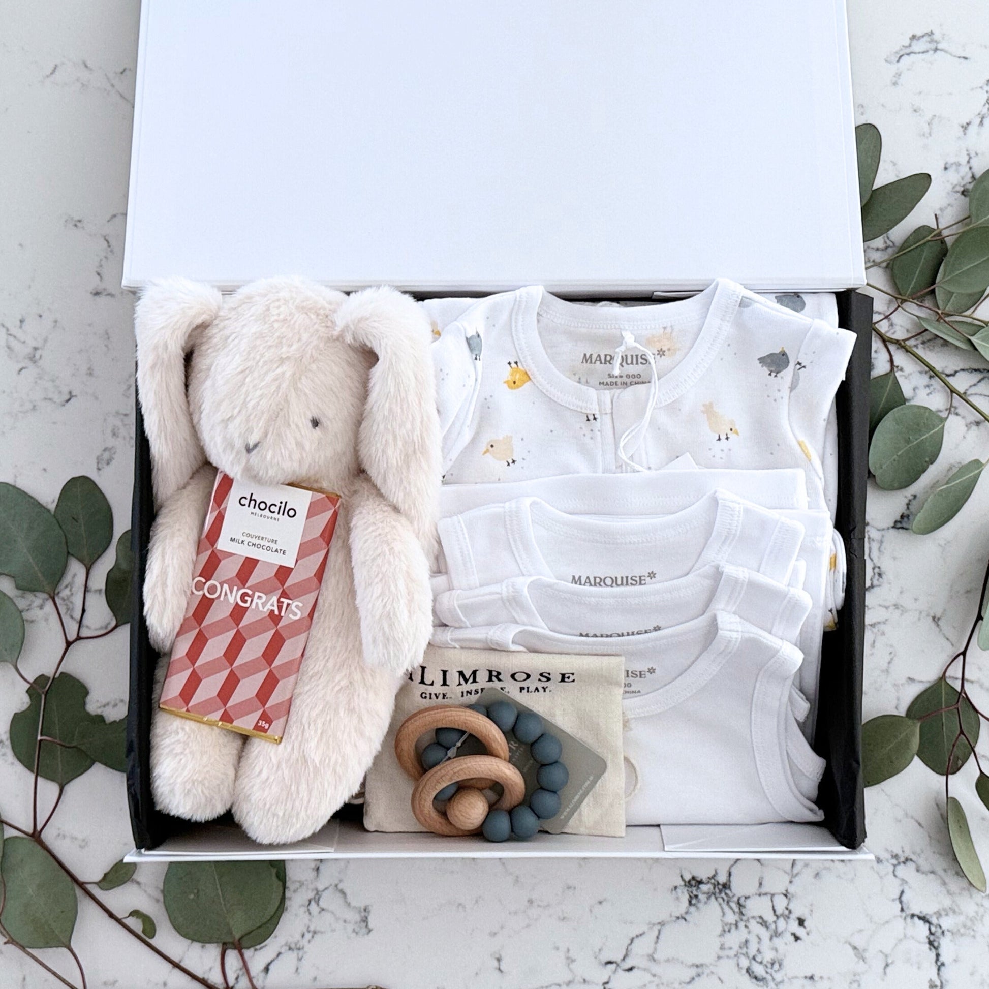 Omoiyari Hello Baby Luxe (gender neutral) Gift hamper box -  blue bunny plush toy, chocolate, Marquise growsuit, rattle and a teething ring with green gum leaves.