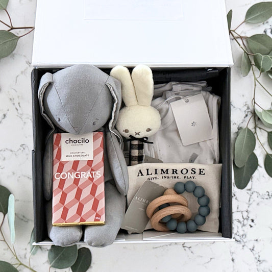 Omoiyari Hello Baby (gender neutral) Gift hamper box -  blue bunny plush toy, chocolate, Marquise growsuit, rattle and a teething ring with green gum leaves.