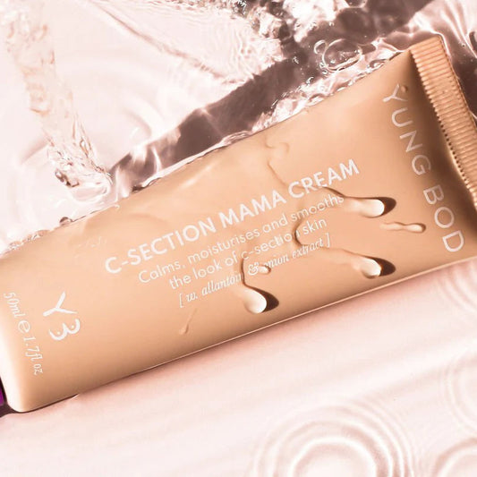 Yung Bod C-Section Mama Cream tube on a textured surface