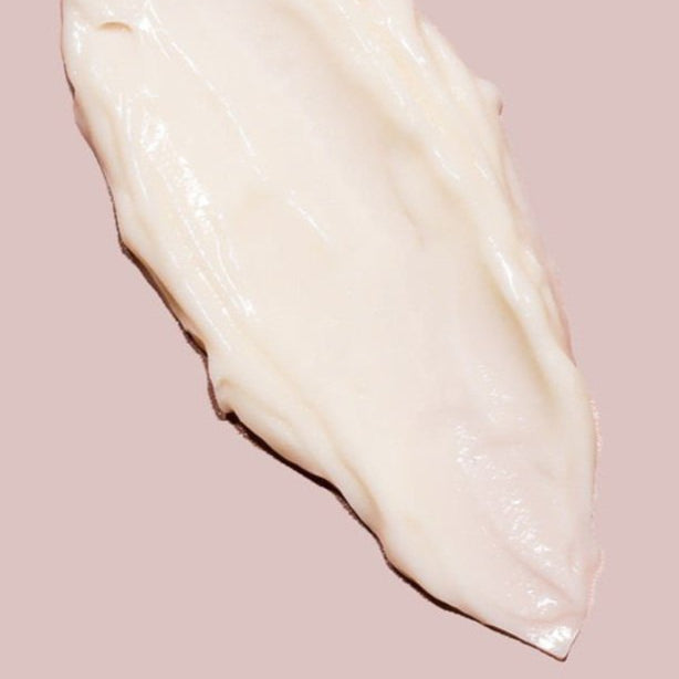 White cream swatch on a pink background