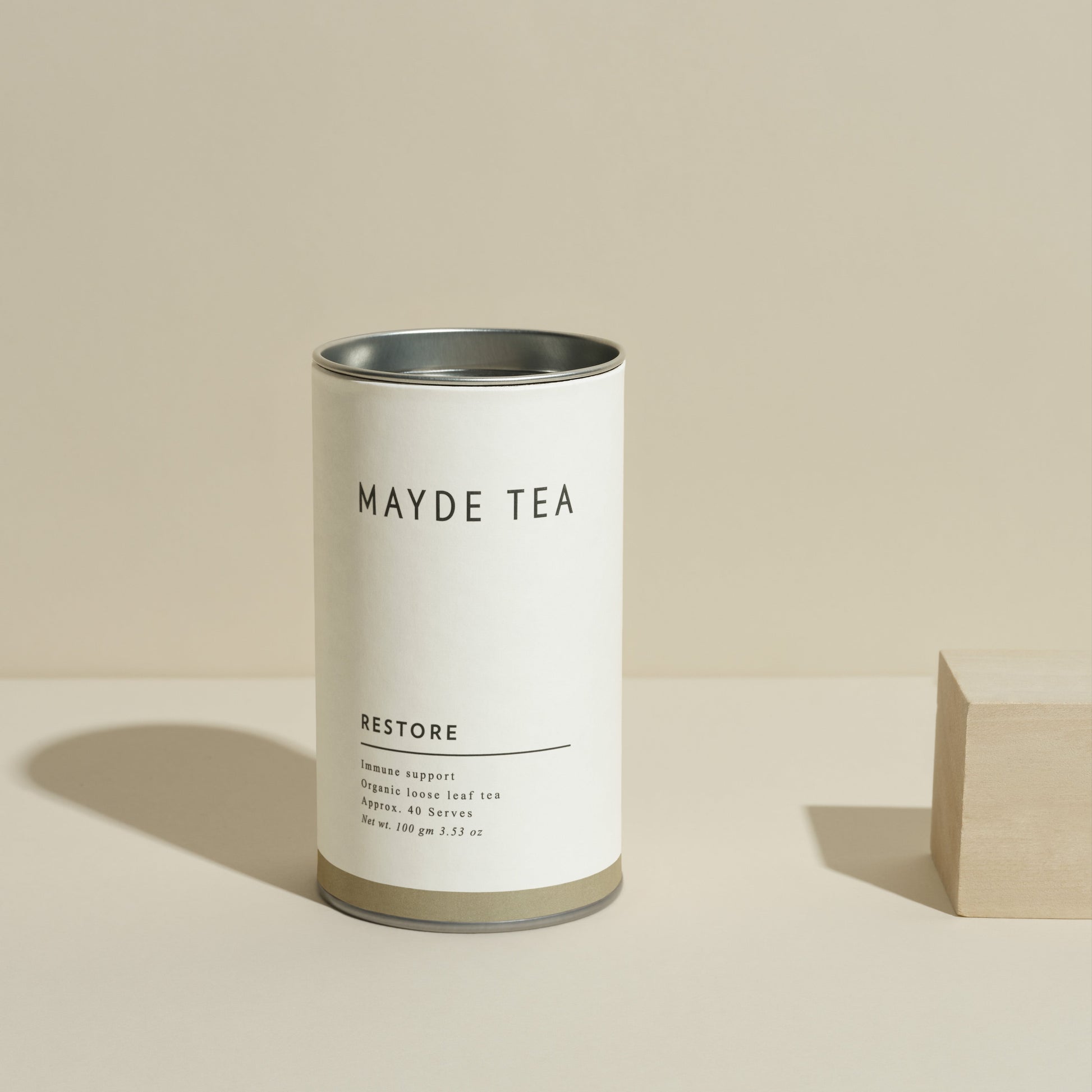 Mayde Tea canister labeled 'Restore' on a beige background